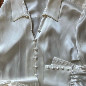 100% silk blouse. Never worn. Beautiful white with button details.